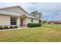 Inviting front exterior featuring a neatly landscaped lawn and charming entrance, offering a welcoming curb appeal at 1714 Fairway Trce, Palmetto, FL 34221