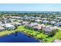 Aerial view of homes in a beautiful lakeside community, with lush green lawns and mature trees at 1806 85Th Nw Ct, Bradenton, FL 34209