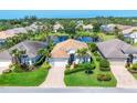 Aerial view of a well-maintained property showing a tiled roof, manicured landscaping, and a charming water view at 1806 85Th Nw Ct, Bradenton, FL 34209