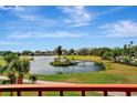 Scenic view of a pond featuring a gazebo, wooden bridge and manicured greenery at 2311 14Th W Ave # 208, Palmetto, FL 34221