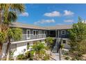 Comfortable two-story condo with balconies, stairs to the second floor, and lush tropical landscaping in the courtyard at 236 Harbor S Dr # 205, Venice, FL 34285