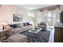 Stylish living room with a comfortable sofa, patterned rug, and natural light at 2802 Swifton Dr # V102, Sarasota, FL 34231