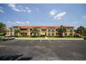 Beautiful condo complex with ample parking, lush landscaping, and barrel tile roofing at 3015 Chianti Ct # 104, Sarasota, FL 34237