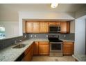 Well-lit kitchen with stainless appliances, granite counters and mosaic backsplash at 3015 Chianti Ct # 104, Sarasota, FL 34237