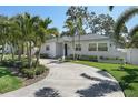 Lovely house with well-maintained lawn, landscaping, and driveway leading to the home's entrance at 322 35Th Ne Ave, St Petersburg, FL 33704