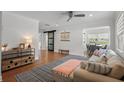 Bright living room featuring stylish furnishings, hardwood floors, and a view into the dining area at 322 35Th Ne Ave, St Petersburg, FL 33704