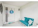 Cozy front porch with seating, decorative wreath and a welcoming mat at 338 Indian Key Way # 111, Englewood, FL 34223
