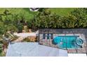 Aerial shot of the backyard pool area with lush landscaping and privacy fence at 3667 Country Place Blvd, Sarasota, FL 34233