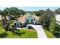 Beautiful home with terra cotta roof tiles, lush landscaping and scenic lake views at 3847 Little Country Rd, Parrish, FL 34219