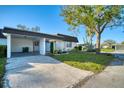 Well-maintained home featuring a spacious driveway leading to a convenient carport at 3904 Ashwood Ln, Sarasota, FL 34232