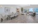 Bright and airy living room and dining area with sleek tile floors and water views at 404 S Shore Dr, Sarasota, FL 34234