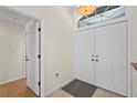 Bright foyer featuring double doors, ceramic tile flooring, and neutral wall paint at 4449 Greenfield Ave, Sarasota, FL 34233