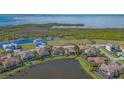 Aerial view of the beautiful homes by the lakes with lush greenery in the community at 5715 Inspiration Ter, Bradenton, FL 34210