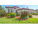 The beautiful Mediterranean home has an attached garage and professionally landscaped front yard at 5715 Inspiration Ter, Bradenton, FL 34210