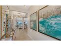 Bright hallway featuring elegant light fixtures and beautiful artwork in this spacious home at 5715 Inspiration Ter, Bradenton, FL 34210