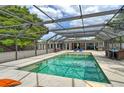 Inviting screened-in pool area with lounge chairs and dining table for outdoor relaxation and entertaining at 6115 6Th Nw Ave, Bradenton, FL 34209