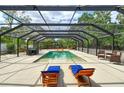 Relaxing screened-in pool area with lounge chairs, dining table, and comfortable seating arrangement at 6115 6Th Nw Ave, Bradenton, FL 34209