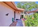 Quaint front entrance with a stone pathway and vibrant, lush landscaping at 6414 Sun Eagle Ln, Bradenton, FL 34210