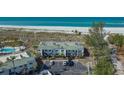 Exterior view of a well-maintained condo complex with tropical landscaping and convenient parking at 6951 Gulf Of Mexico Dr # 14, Longboat Key, FL 34228