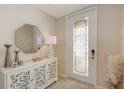 Inviting foyer with a decorative glass door, stylish console table, and modern decor at 7019 Grand Estuary Trl # 101, Bradenton, FL 34212