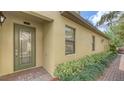 Elegant front entrance showcasing a decorative glass door and manicured landscaping at 7019 Grand Estuary Trl # 101, Bradenton, FL 34212