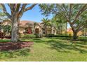 Inviting one-story house with tile roof and lush greenery, shaded by mature trees at 7441 Myrica Dr, Sarasota, FL 34241