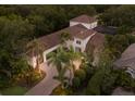 A stunning aerial view of the home, with lush landscaping, a brick driveway, and a glimpse of the home's entrance at 7532 Greystone St, Lakewood Ranch, FL 34202