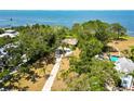 Aerial view showcasing a charming home with a long driveway and a glimpse of a pool nearby at 7620 Westmoreland Dr, Sarasota, FL 34243