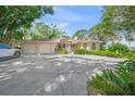 Charming home with an attached two-car garage, lovely landscaping, and a spacious driveway at 7620 Westmoreland Dr, Sarasota, FL 34243