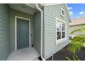 Close-up of a modern front door with white trim and a nearby window at 7743 Ridgelake Cir, Bradenton, FL 34203
