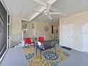 Inviting screened-in lanai featuring an outdoor ceiling fan, comfortable seating, and stylish decor at 8404 Imperial Cir # 8404, Palmetto, FL 34221