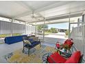 Inviting screened-in lanai featuring an outdoor ceiling fan, comfortable seating, and stylish decor at 8404 Imperial Cir # 8404, Palmetto, FL 34221