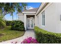 Inviting front entrance with double doors and a well-manicured garden at 8630 51St E Ter, Bradenton, FL 34211