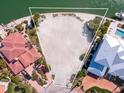 Aerial view of an oversized waterfront lot with lush landscaping, ideal for building your dream home at 894 Freeling Dr, Sarasota, FL 34242