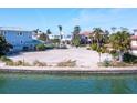 Prime waterfront vacant lot ready for building with seawall and lush tropical landscaping along the water's edge at 894 Freeling Dr, Sarasota, FL 34242