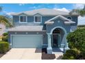 Charming two-story home with an arched entryway, beautiful paint and mature landscaping at 9307 Raes Creek Pl, Palmetto, FL 34221