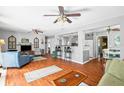 Spacious living room with hardwood floors, ceiling fans, and great flow into the kitchen and dining area at 1108 65Th W Ave, Bradenton, FL 34207