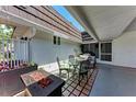 Cozy outdoor patio featuring a dining set and a charming fire pit for relaxation at 1520 Lakeside Way # 147, Sarasota, FL 34232