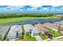 Stunning aerial view overlooking the community showcasing a pristine golf course and a tranquil lake at 15722 San Lazzaro Ave, Lakewood Ranch, FL 34211