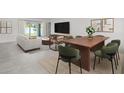 Modern dining area featuring stylish furniture, open to bright living space, and sliding glass doors at 16206 Arcaro Ave, Port Charlotte, FL 33954