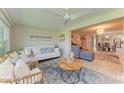 Bright and airy living room with comfortable seating, stylish decor, light-colored flooring, and an open floor plan at 1622 Stafford Ln # 1205, Sarasota, FL 34232
