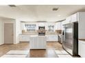 Bright kitchen with white cabinets, stainless steel appliances, and a center island at 2151 Upton Ave, Sarasota, FL 34232