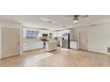 Well-lit kitchen boasting stainless steel appliances, white cabinets, and a convenient center island at 2151 Upton Ave, Sarasota, FL 34232