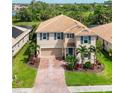 Overhead view of home showing its manicured landscaping, paved driveway, and two-car garage at 2177 Weaver Bird Ln, Venice, FL 34292