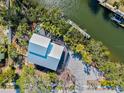 Waterfront property featuring a private dock, canal access, and lush landscaping, perfect for boating at 234 85Th St, Holmes Beach, FL 34217