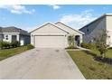Single story home featuring a well-maintained lawn and long driveway leading to a two-car garage at 2812 Rock Sound St, Bradenton, FL 34208