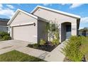 Well-maintained home exterior with landscaped front yard, walkway, and attached two-car garage at 2812 Rock Sound St, Bradenton, FL 34208