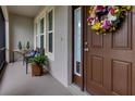 Charming front porch with a decorative wreath, bench seating and an inviting entryway into the home at 2918 130Th E Ave, Parrish, FL 34219