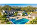 Community pool area featuring a spacious sundeck, tropical landscaping, and comfortable seating for residents at 304 108Th W St, Bradenton, FL 34209