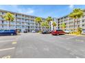 Condominium building featuring resident parking, landscaping, and well-maintained exteriors at 3204 Lake Bayshore Dr # 407, Bradenton, FL 34205